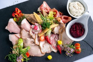 A platter of cold cuts, pates, and roasts served with fresh vegetables, pickles and sauces(6 pln/50g)